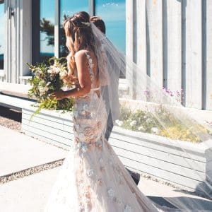 Bride wearing Milla Nova Goldie wedding gown and Senna bridal hair vine